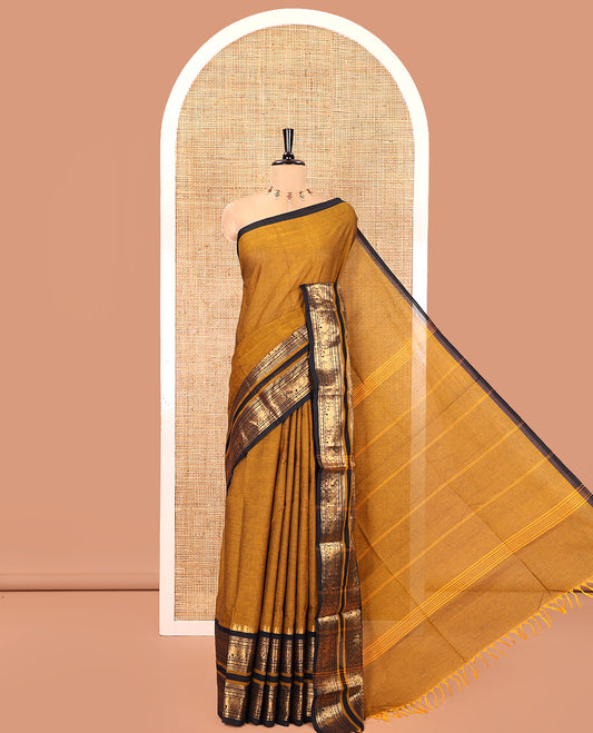 Mustard Plain Chettinad Cotton Saree, Complemented by a Contrast Rettai Pettu One-Sided Zari Border of Temple, Paisa, Elephant, and Peacock Designs, Subtly Striped Pallu, and Paired with a Matching Blouse