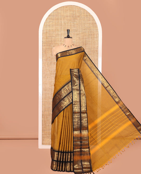 Mustard Plain Chettinad Cotton Saree, Complemented by a Contrast Rettai Pettu Zari Border of Thread-Temple, Coin, Elephant, and Peacock Designs, Subtly Striped Pallu, and Paired with a Matching Blouse