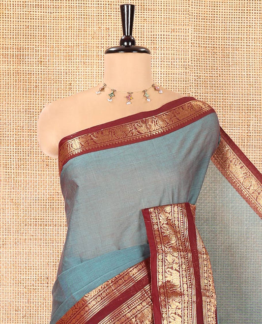 Teal Plain Chettinad Cotton Saree, Complemented by a Contrast Traditional Zari Design Rettai Pettu Border of Peacock and Elephant Designs, Pallu of Stripes, and Paired with a Matching Blouse