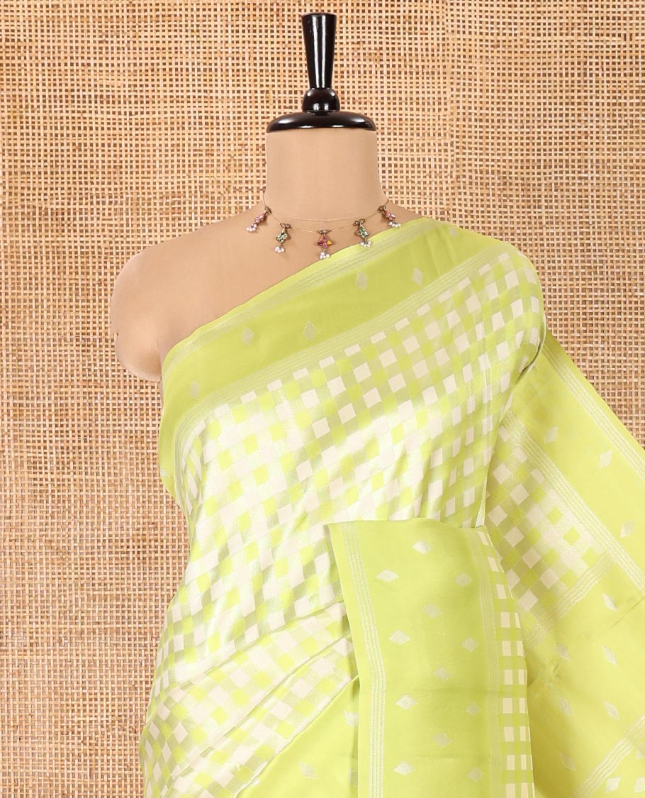 Green Kanchi Silk Saree, Accentuated with Checked Design on Its Body, Highlighted by a Self-Border of Diamond Patterns, Pallu Steeped with Buttas, and Paired with a Matching Blouse