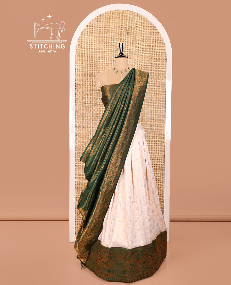 Cream and Green Banaras Softy Half-Saree Featuring Jacquard Design All Over the Skirt, Adorned with a Contrast Geometric Zari Design Border, Paired with a Jacquard Blouse, and a Banaras Softy Dhavani with Floral Jaal Jacquard Design