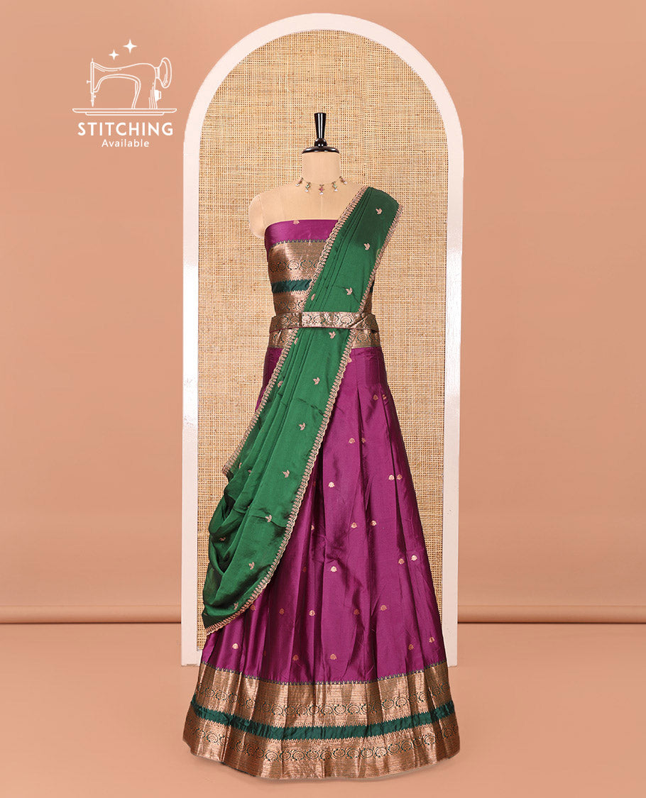 Purple and Green Semi-Banarasi Half-Saree Featuring Zari Buttas Skirt, Complemented by Contrast Rettai Pettu, Traditional Border of Floral Creeper Designs, Paired with a Matching Blouse, and a Satin Georgette Embroidered Scallop Dhavani