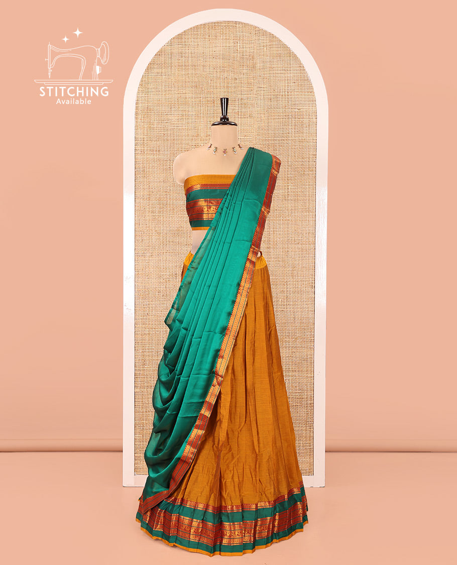 Mustard-Green Mercerised Cotton Half-Saree Features Plain with Contrast Traditional Zari Varisai Pettu Annam-Motif Bordered Skirt, Paired with a Matching Blouse, and Comes with a Contrast Zari-Bordered Dhavani