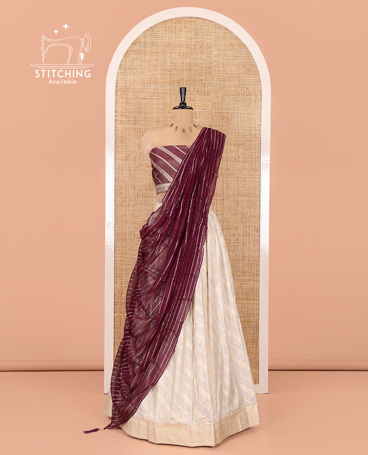 Cream-Purple Semi-Banarasi Half-Saree Features Leheriya Striped Skirt, Contrast Leheriya Striped Blouse, Georgette Striped Dhavani