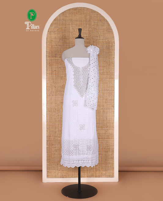 White material churidar set, stone work with Schiffli style embroidered georgette top, American Crape bottom, and polka dotted printed mirror work dupatta