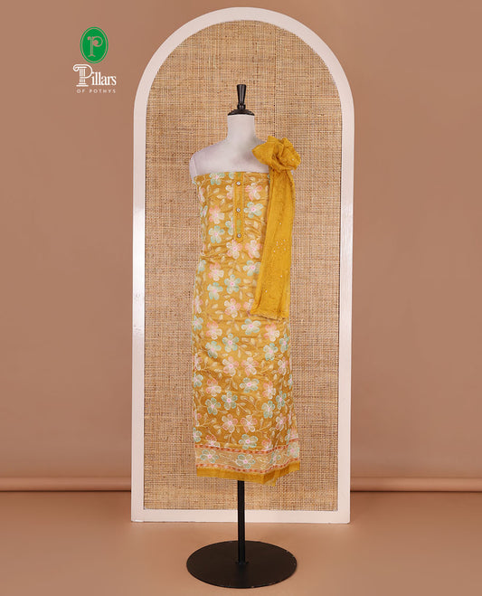 Mustard churidar material set, floral print with thread outlined organza top, plain santoon bottom, and floral vine sequins embroidered organza dupatta