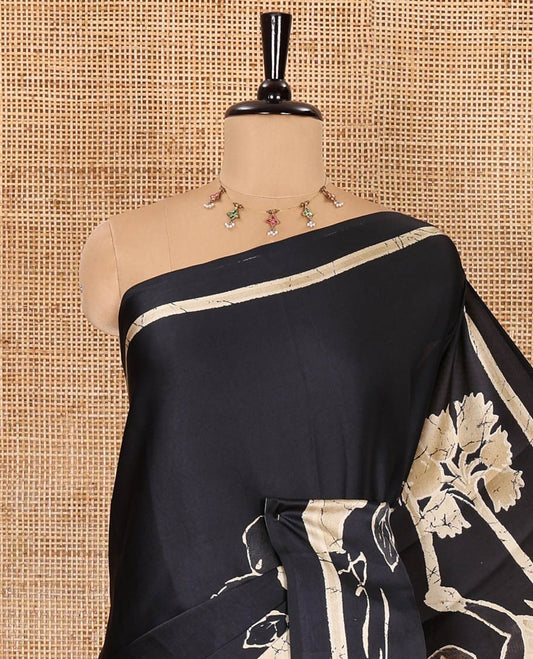 Black jungle-theme tree, animal, and human motifs batik printed satin crepe saree, printed border, printed pallu, and a matching blouse