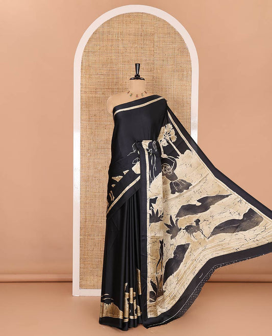 Black jungle-theme tree, animal, and human motifs batik printed satin crepe saree, printed border, printed pallu, and a matching blouse