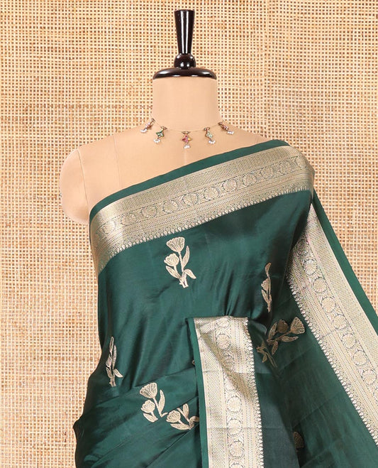 Bottle Green Semi-Banaras Satin Silk Saree, Beautified with Floral Zari Buttas Across Its Body, Highlighted by Traditional Zari Design Border, Grand Zari Woven Palu of Jaal Designs, and Paired with a Matching Blouse