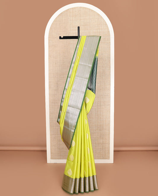 Yellow zari buttas soft silk saree, contrast traditional zari design border, and intricate pallu