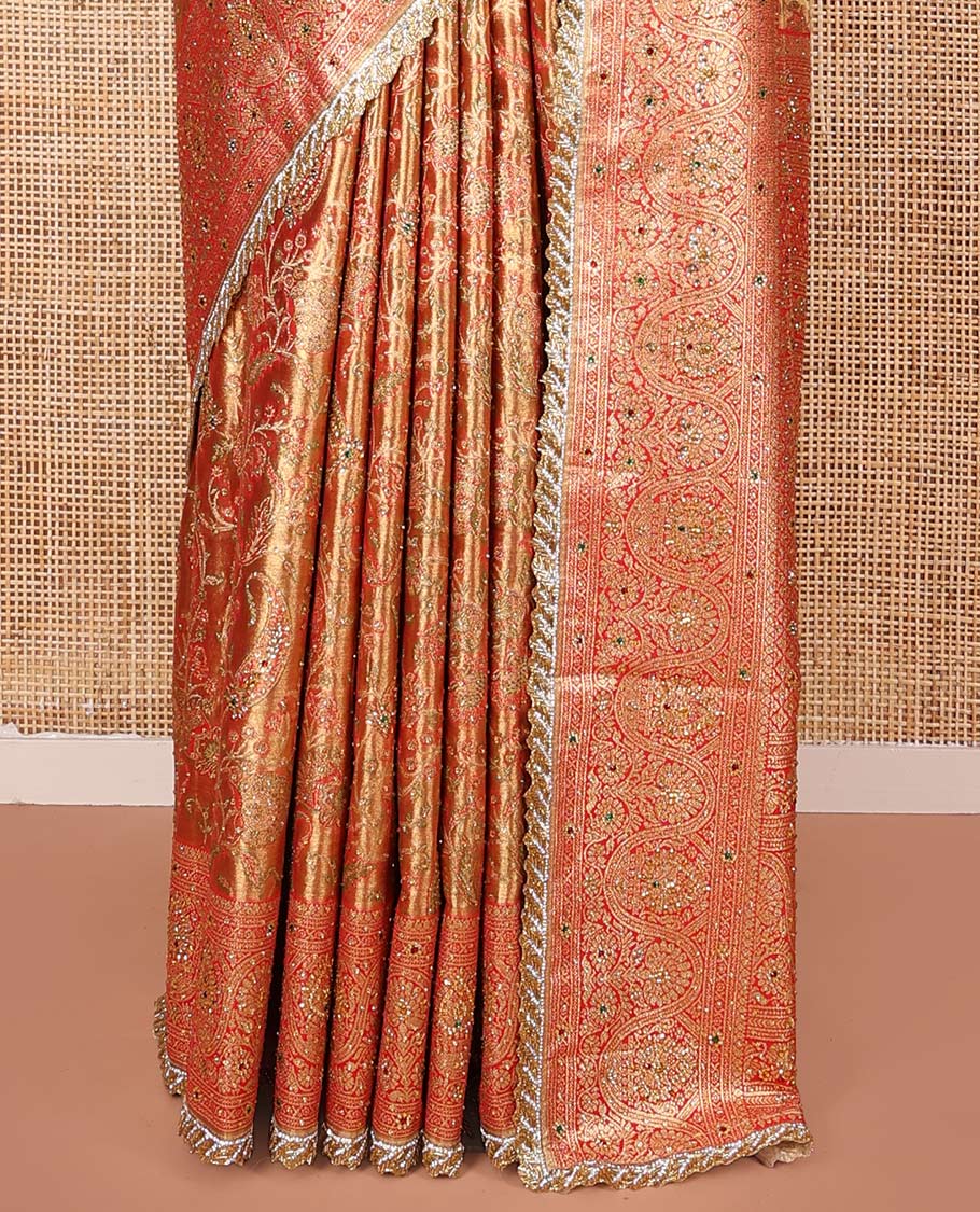 Gold Vastrakala Silk Saree, Decorated with Floral Jaal and Stone Work, Complemented by Contrast Traditional Zari and Stone Embroidered Scallop Border, Gleaming Grand Zari-Stone Work Pallu, and Paired with Contrast Heavy Stone Embroidered Blouse
