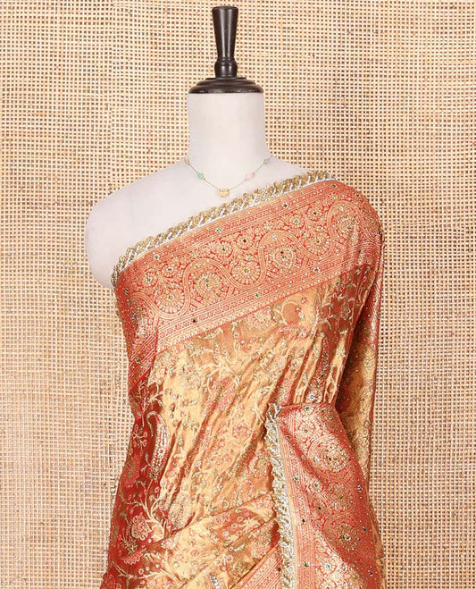 Gold Vastrakala Silk Saree, Decorated with Floral Jaal and Stone Work, Complemented by Contrast Traditional Zari and Stone Embroidered Scallop Border, Gleaming Grand Zari-Stone Work Pallu, and Paired with Contrast Heavy Stone Embroidered Blouse
