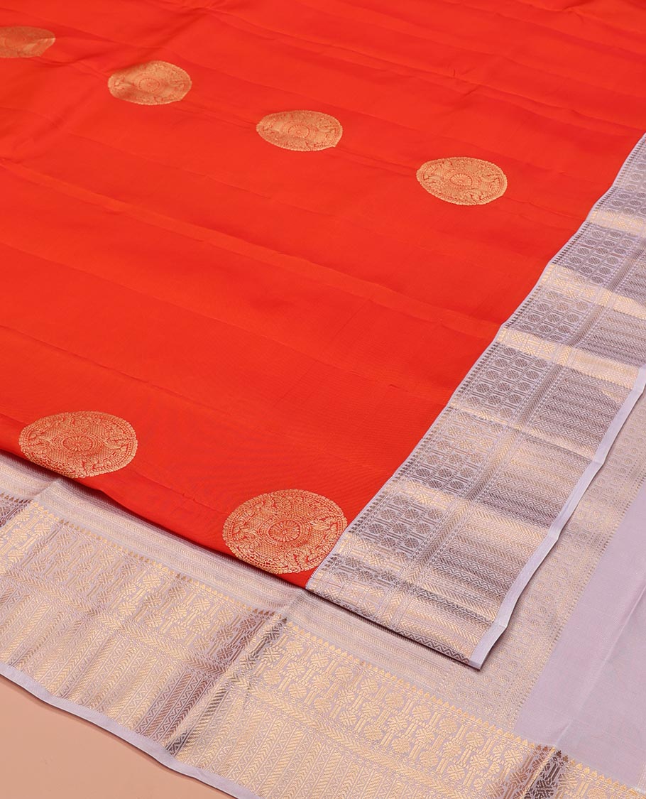 Orange Vasundhara Lite-Silk Mix Saree, Embellished with Chakram Zari Buttas All Over Its Body, Complemented by a Contrast Border of Rekku, Rudraksham, Neli, and Kathir Designs, Artfully Decked Up Pallu of Kathir Designs, and Paired with a Contrast Blouse