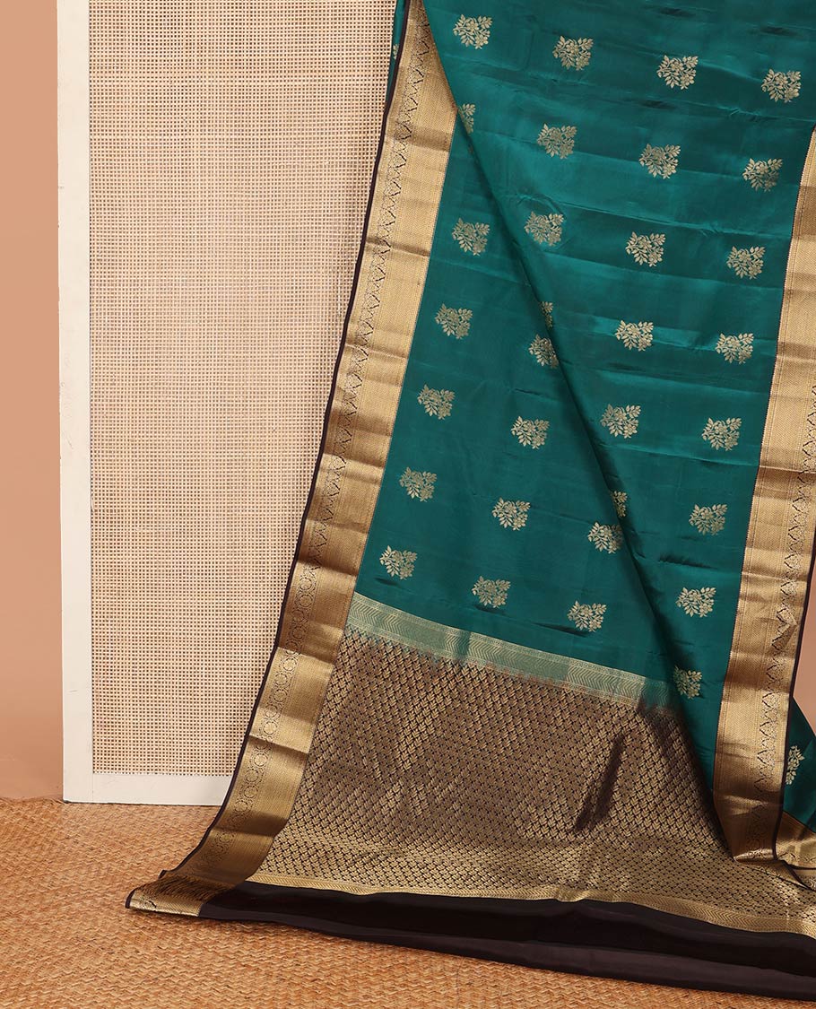Green zari buttas Vasundhara silk mix saree, contrast border of rekku, muthu, poun, vanki, and zari designs, and leaf vine design pallu