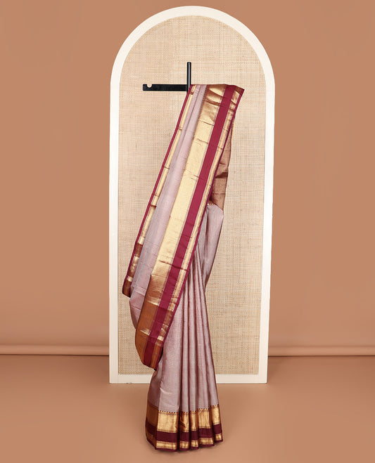 Brown micro-checked silk saree, contrast rettai pettu border of thazampoo rekku, banaras, muthu, and geometric designs, and jaal pallu