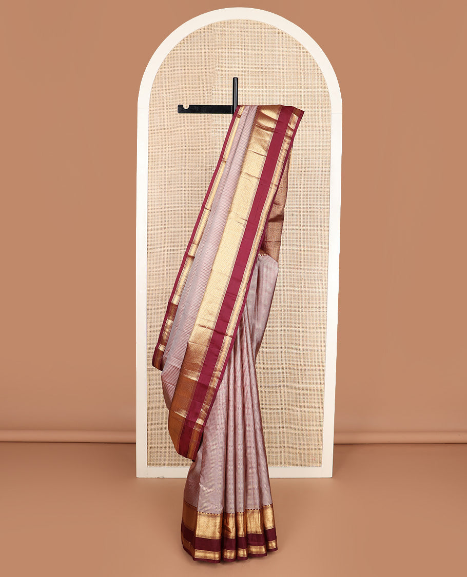 Brown micro-checked silk saree, contrast rettai pettu border of thazampoo rekku, banaras, muthu, and geometric designs, and jaal pallu