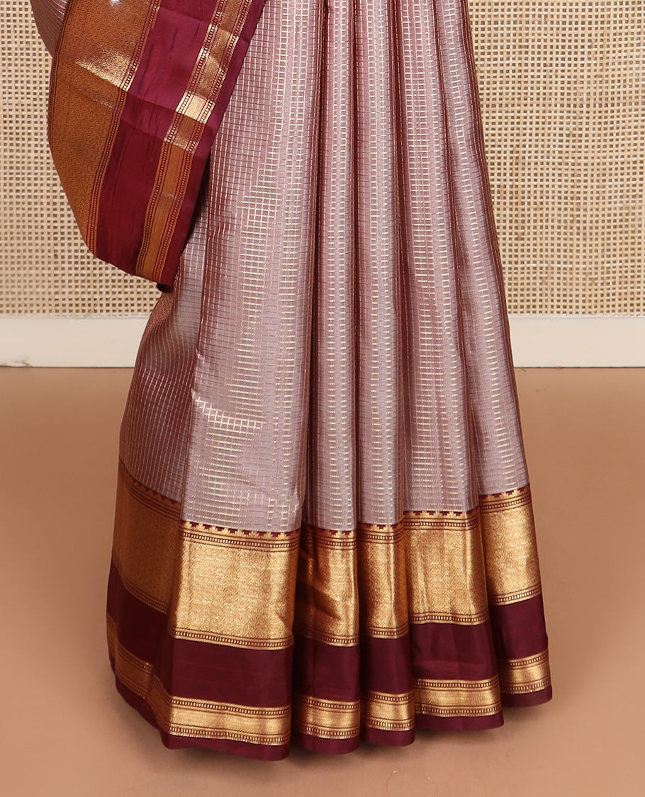 Brown micro-checked silk saree, contrast rettai pettu border of thazampoo rekku, banaras, muthu, and geometric designs, and jaal pallu