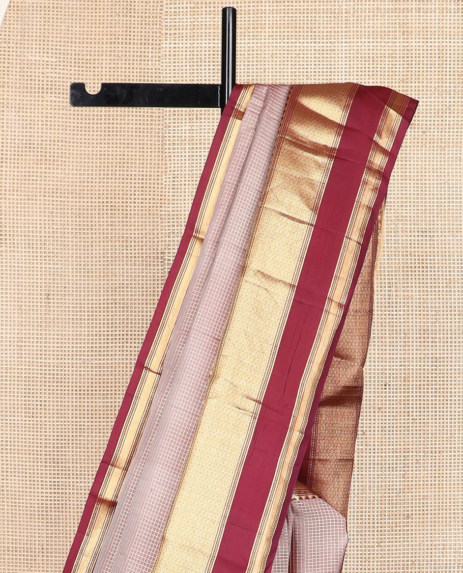 Brown micro-checked silk saree, contrast rettai pettu border of thazampoo rekku, banaras, muthu, and geometric designs, and jaal pallu