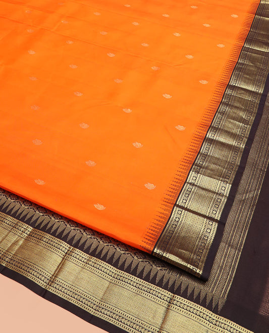 Orange Vasundhara Silk Saree Beautified with Mayil Buttas, Complemented by a Contrast Thazampoo Rekku Border of Muthu, Banaras, Kathir, and Mayil Kann Designs, Pallu of Jaal Designs, and Paired with a Contrast Zari-Bordered Blouse