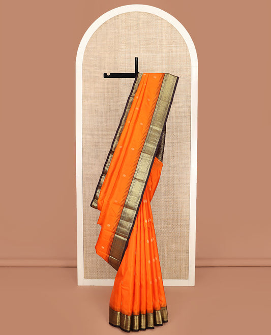 Orange Vasundhara Silk Saree Beautified with Mayil Buttas, Complemented by a Contrast Thazampoo Rekku Border of Muthu, Banaras, Kathir, and Mayil Kann Designs, Pallu of Jaal Designs, and Paired with a Contrast Zari-Bordered Blouse