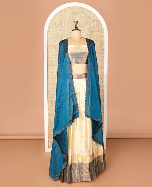 Cream-blue art-silk half-saree, zari buttas with contrast traditional design bordered skirt, a matching blouse, and scallop stone work dhavani