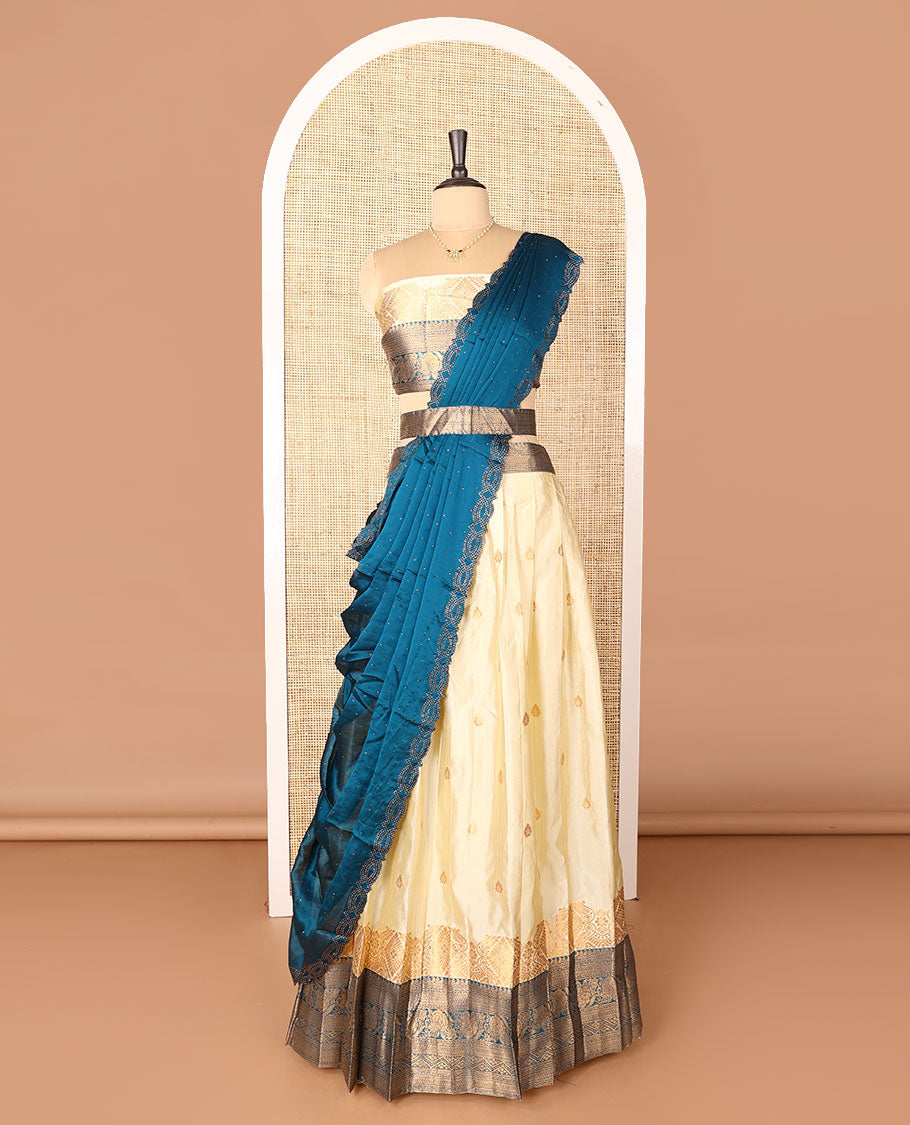 Cream-blue art-silk half-saree, zari buttas with contrast traditional design bordered skirt, a matching blouse, and scallop stone work dhavani