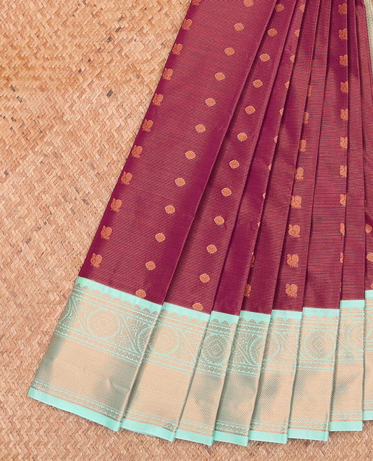 Burgundy Budget Silk Saree, Mesmerized with Peacock and Chakram Buttas on Its Body, Complemented by a Contrast Traditional Zari Border, Gleaming Jaal Pallu, and Paired with a Contrast Blouse