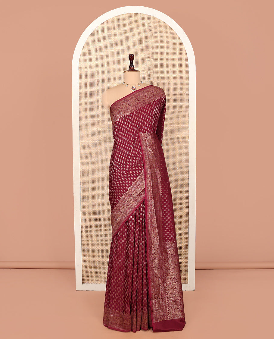 Light Maroon Fancy Crepe Saree, Steeped with Buttas, Highlighted by a Floral Creeper Border, Intricately Designed Pallu, and a Matching Blouse