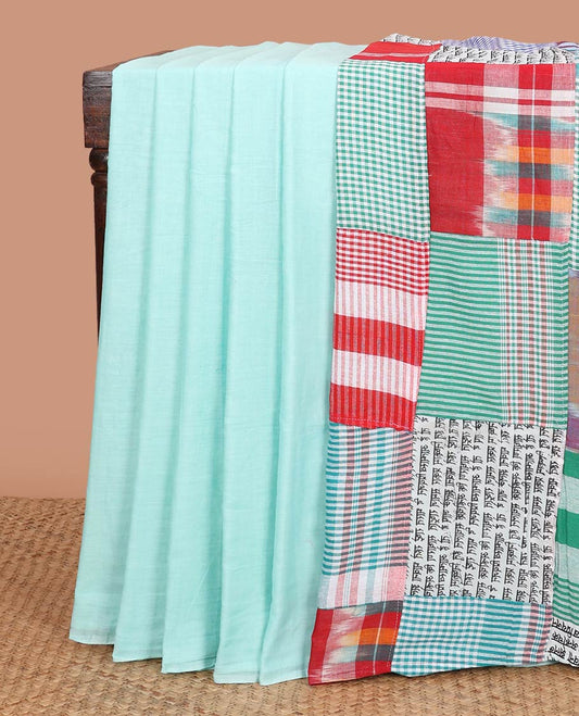 Borderless celeste blue plain khadi cotton saree, contrast kaleidoscope-colored patchwork style pallu of micro-checks, ikkat, and hindi typography designs with colorful tassels