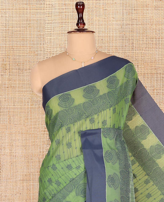 Green Semi-Silk Cotton Saree, Sparsely Woven with Buttas and Floral-Paisley Design All Over Its Body, Complemented by Contrast Border, Sparsely Woven Pallu of Jaal Designs, and Paired with a Matching Blouse