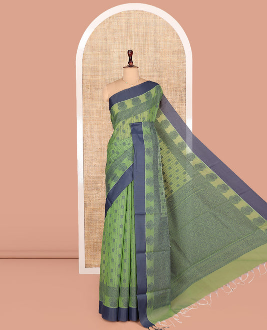 Green Semi-Silk Cotton Saree, Sparsely Woven with Buttas and Floral-Paisley Design All Over Its Body, Complemented by Contrast Border, Sparsely Woven Pallu of Jaal Designs, and Paired with a Matching Blouse