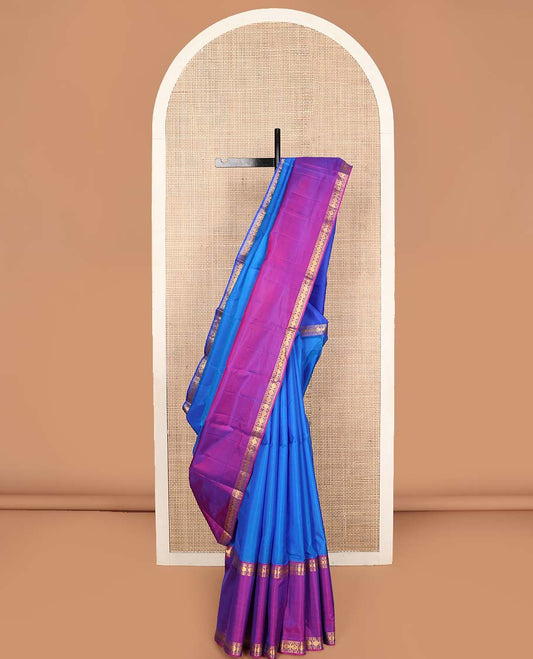 Blue plain Kanchipuram silk saree, contrast ganga jamuna rettai pettu border of rudraksham designs, and zari striped pallu