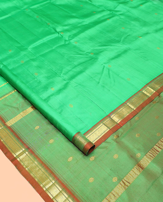 Green Kanchipuram Silk Saree, Embellished with Zari Buttas All Over Its Body, Complemented by a Contrast One-Sided Border of Banaras, and Jaal Designs, Pallu of Zari Designs, and Comes Without a Blouse