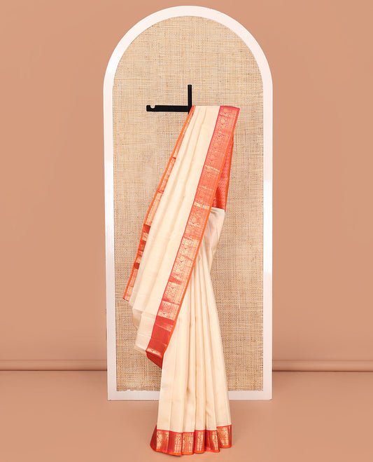 Sandal Vasundhara Silk Saree, Sparsely Woven with Zari Buttas on Its Body, Complemented by Contrast Border of Rudraksham, Mayil, Chakram, Muthu, and Mayil Kann Designs, Grandly Decked Up Pallu, and Paired with a Contrast Blouse