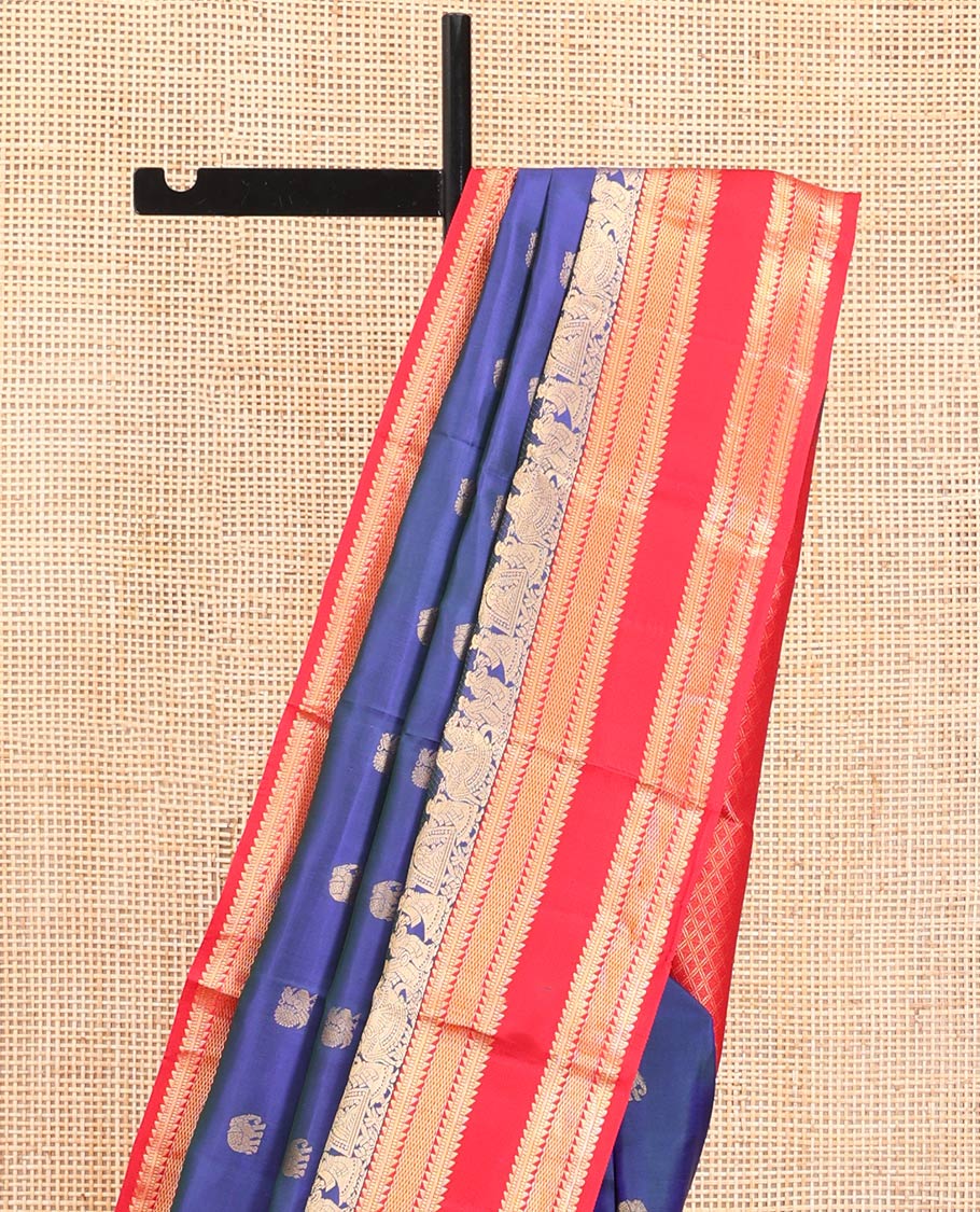 Blue Vasundhara Silk Saree, Dazzled with Mayil and Yaanai Buttas All Over Its Body, Complemented by Contrast Border of Wedding-Theme Motifs, Ara Bogudi, Muthu, and Ara Maadam Designs, Grand Jaal Pallu, and Paired with a Contrast Blouse