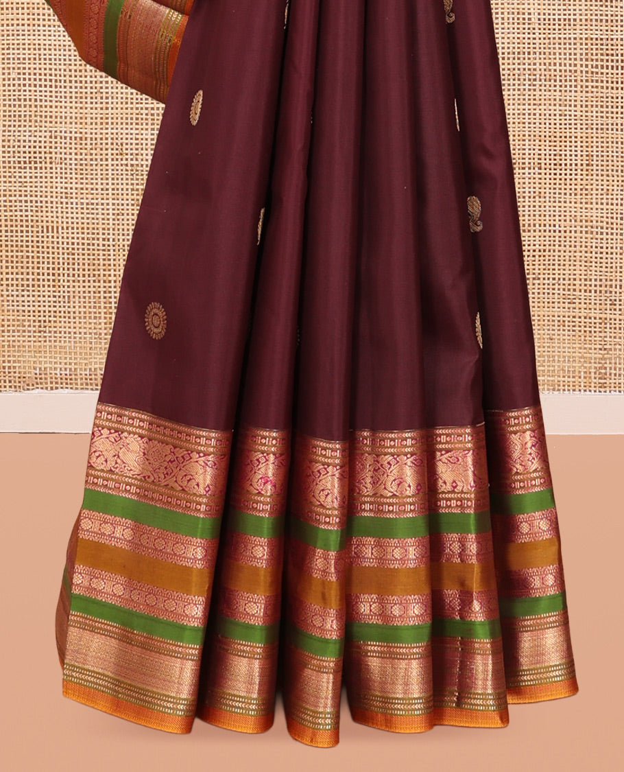 Brown Vasundhara Silk Saree, Delicately Woven with Mayil-Chakram Buttas, a Contrast Border of Kathir, Mayil, Yaanai, Muthu, Neli, and Laddu Kamalam Designs, a Grand Pallu, and a Contrast Blouse
