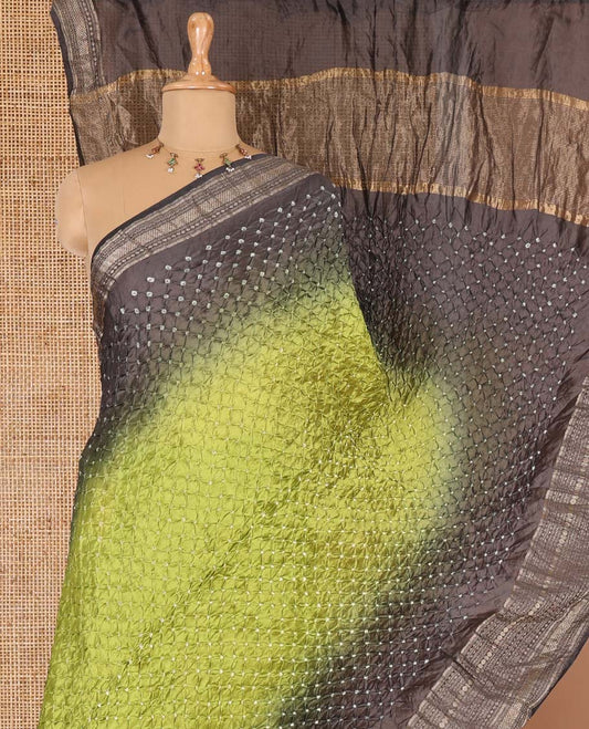 Green bandhani dotted bandhani silk saree, contrast traditional motifs steeped border, and zari striped pallu