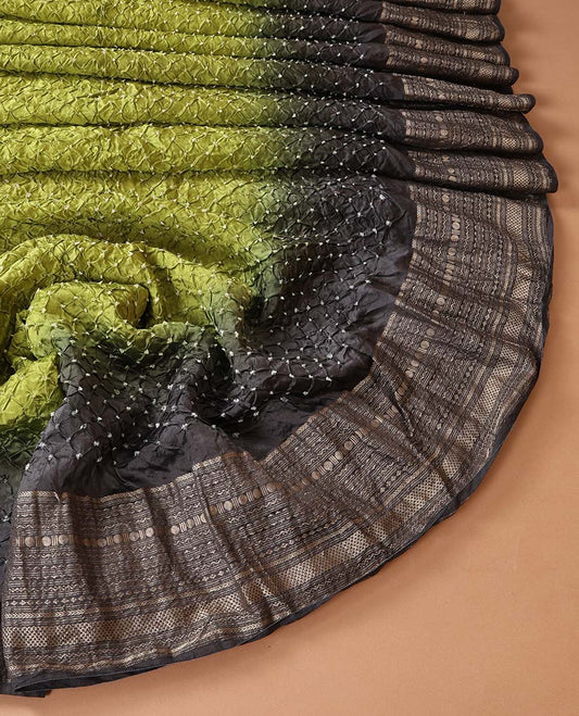 Green bandhani dotted bandhani silk saree, contrast traditional motifs steeped border, and zari striped pallu