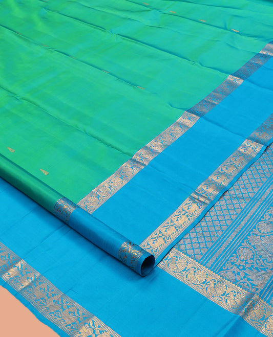 Green Kanchipuram Silk Saree, Ornamented with Zari Buttas, Complemented by Contrast Rettai Pettu Border of Rekku, Muthu, and Mayil Designs, Jaal Pallu, and Contrast Blouse