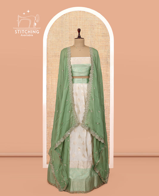 Cream-Green Banarasi Half-Saree, Bedecked with Buttas Skirt, a Contrast Traditional Lace Border, Matching Blouse, and Scallop Embroidered Dupatta