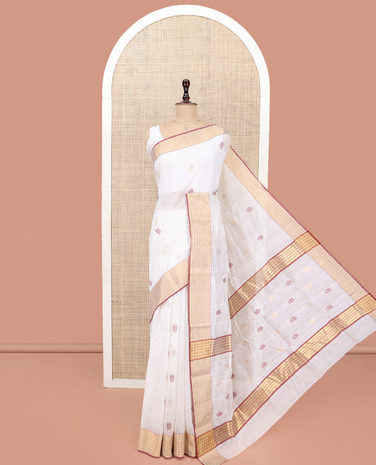 White Chanderi Cotton Saree, Delicately Woven with Leaf Buttas All Over Its Body, Highlighted by a Zari Striped Border, Pallu Steeped with Buttas, and Paired with a Matching Blouse