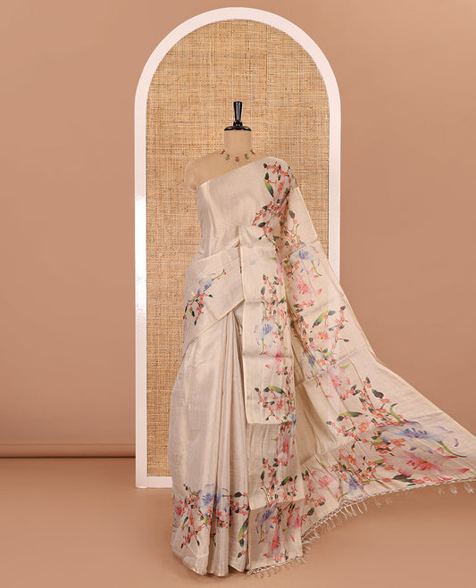 Cream plain tissue saree with hand painting style floral motifs printed border, and pallu and a printed blouse