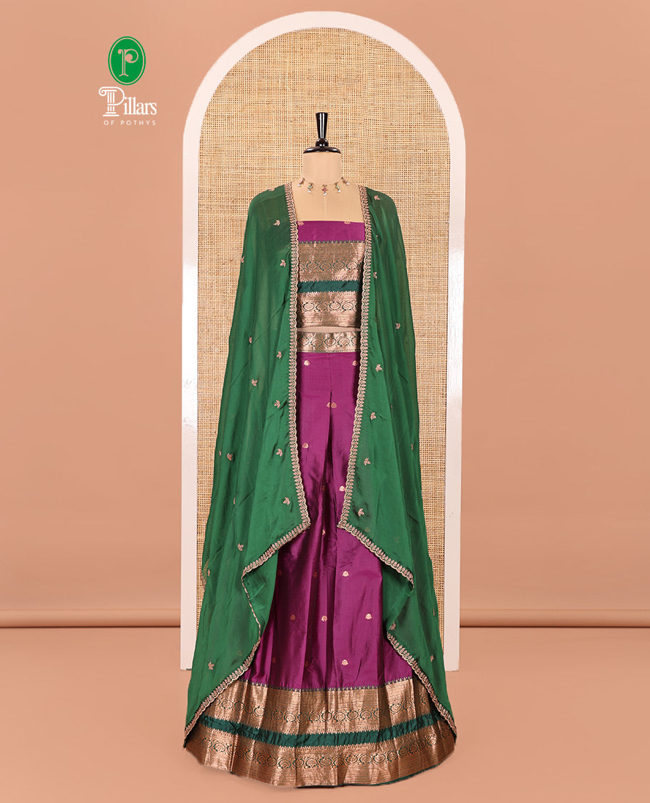 Purple and Green Semi-Banarasi Half-Saree Featuring Zari Buttas Skirt, Complemented by Contrast Rettai Pettu, Traditional Border of Floral Creeper Designs, Paired with a Matching Blouse, and a Satin Georgette Embroidered Scallop Dhavani
