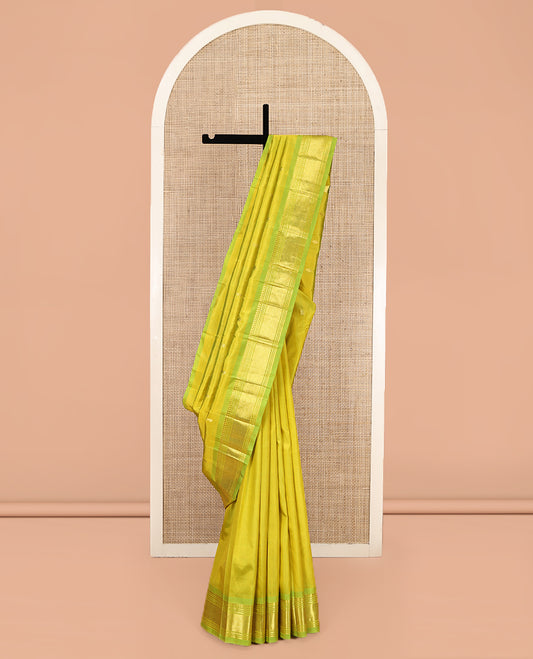 Green Kanchipuram Silk Saree Featuring Zari Buttas, Complemented by a Contrast One-Sided Border of Panner Sombu, Banaras, Muthu, and Jaal Design, Zari Design Pallu, and No Blouse