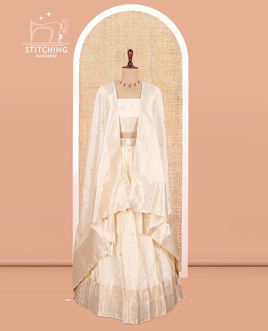 Cream Semi-Banarasi Half Saree, Zari Buttas Top, a Matching Blouse, and Intricately Designed Dhavani