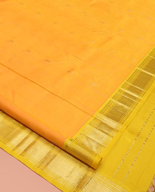 Yellow Kanchipuram Silk Saree, Subtly Sparkled with Zari Buttas, a Contrast One-Sided Border of Panner Sombu, Banaras, Muthu, and Jaal, Zari-Woven Pallu, and No Blouse