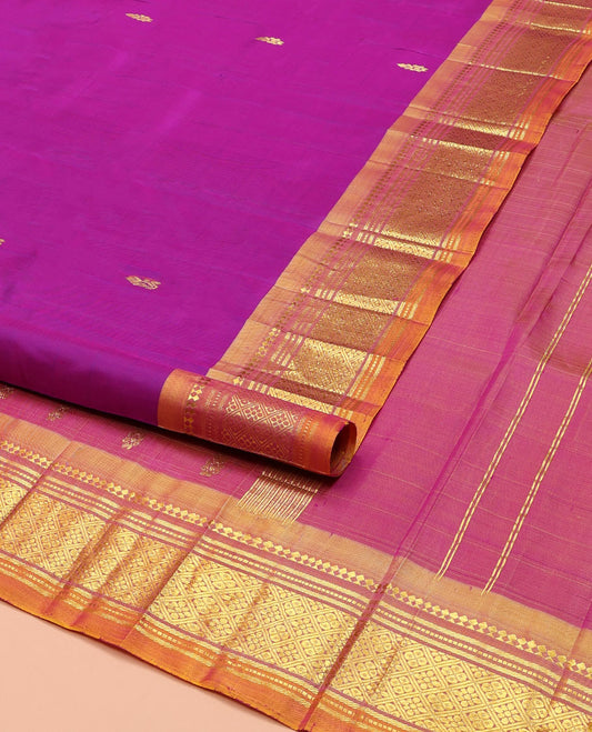 Rani Pink Kanchipuram Silk Saree, Embellished with Zari Buttas on Its Body, Complemented by a Contrast One-Sided Border of Paneer Sombu, Banaras, Muthu and Jaal Designs, Pallu of Zari Designs, and Comes Without a Blouse