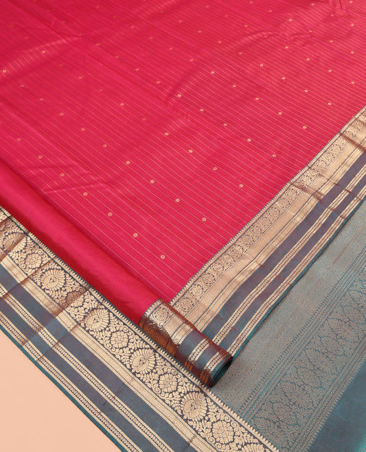 Red Vasundhara Silk Saree, Spotlighted with Zari Buttas and Stripes, a Contrast Rettai Pettu Border of Thilakam, Kamalam, Banaras, and Muthu Designs, Jaal Pallu, and Contrast Blouse
