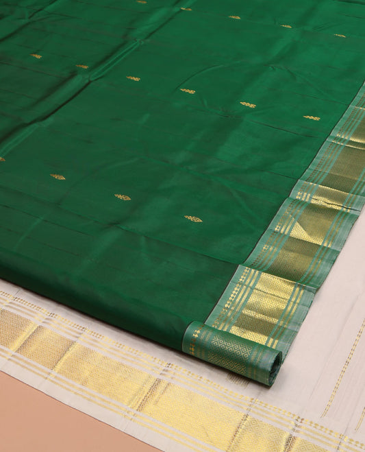 Green Kanchipuram Silk Saree, Delicately Woven with Zari Buttas on Its Body, Complemented by a Contrast One-Sided Border of Panner Sombu, Banaras, and Mayil Kann Designs, Pallu of Zari Designs, and Comes Without a Blouse