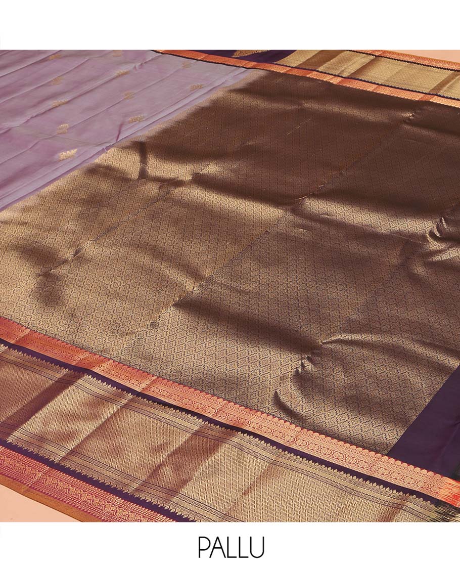 Lavender Vasundhara Lite Silk Mix Saree, Spotlighted with Zari Buttas on Its Body, Complemented by a Contrast Border of Thilakam Mokku, Mayil, and Yaali Designs, a Grandly Zari Decked Up Pallu, and Paired with a Contrast Blouse